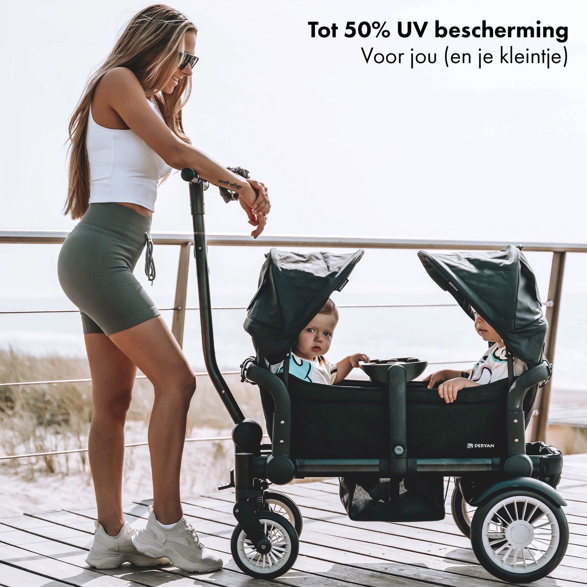 The DERYAN wagon in black is a foldable cart that can be used to transport children and belongings. The model has a sturdy frame, four wheels, and a foldable design. The wagon is suitable for use during outings and outdoors.