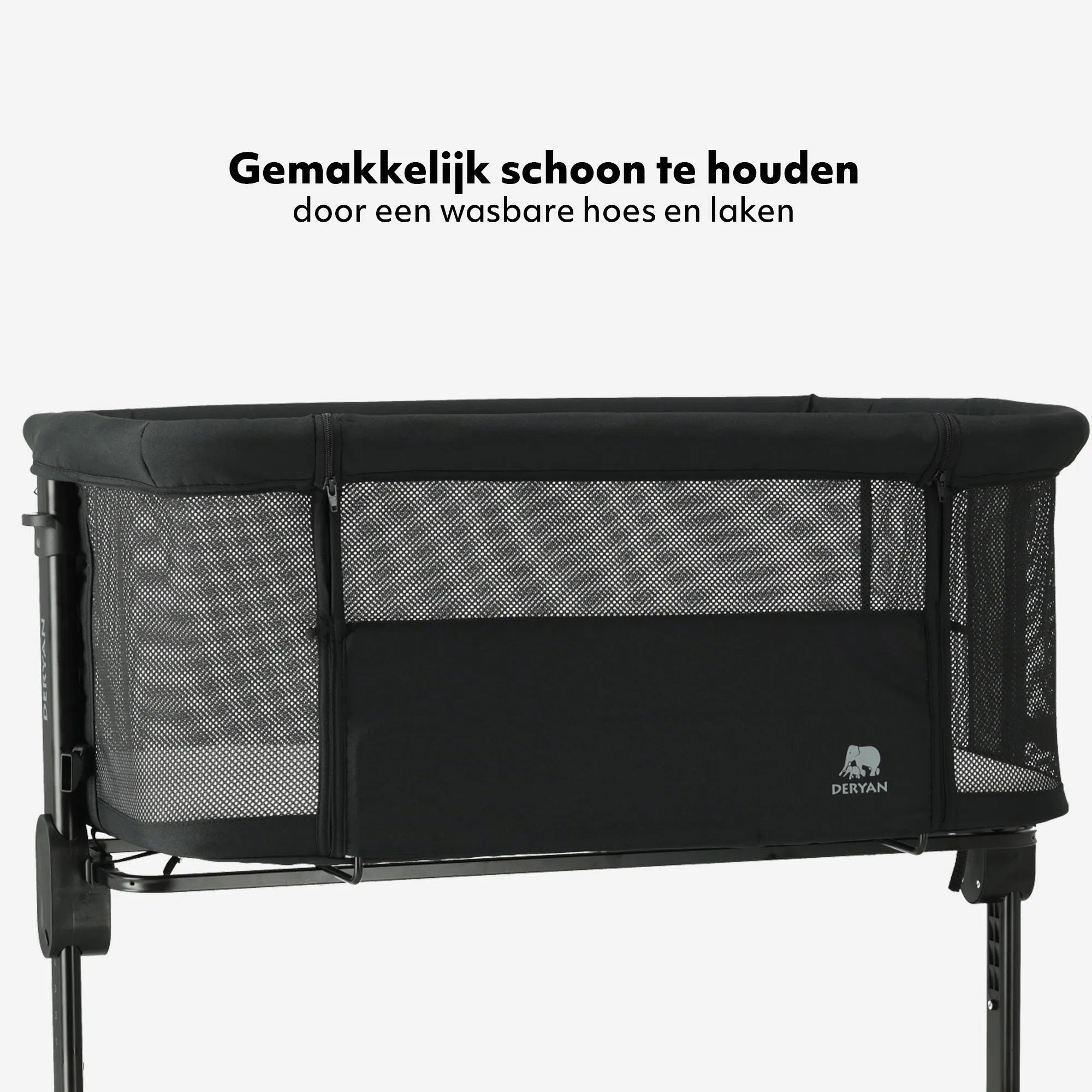 The DERYAN co-sleeper in black is a crib that can be placed next to the bed for use with young babies. The model has an adjustable height, an open side, and a stable frame. The co-sleeper is intended for use during the first months after birth.