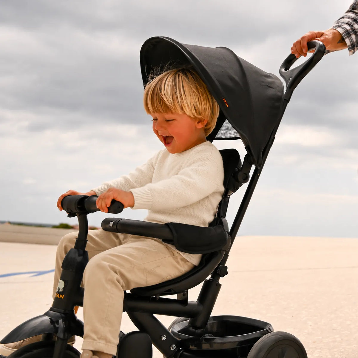 Adventurer tricycle, black, with push bar, adjustable handlebars, and enclosed chain guard