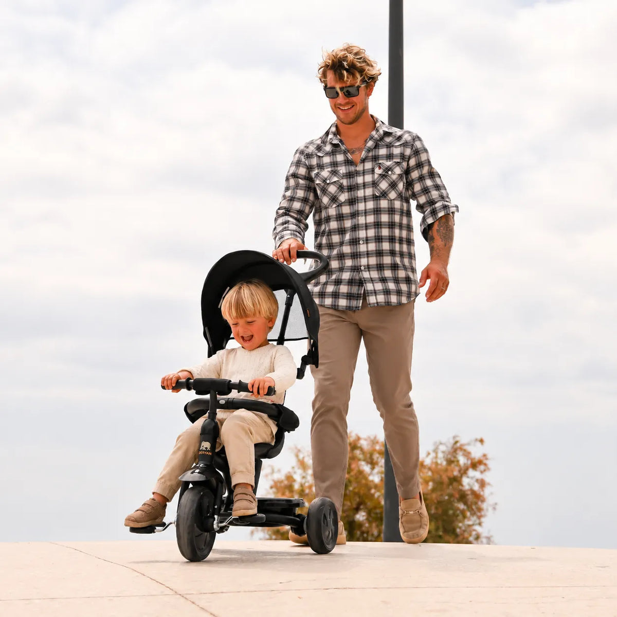 Adventurer tricycle, black, with push bar, adjustable handlebars, and enclosed chain guard