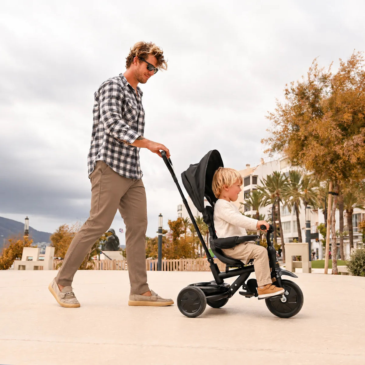 Adventurer tricycle, black, with push bar, adjustable handlebars, and enclosed chain guard